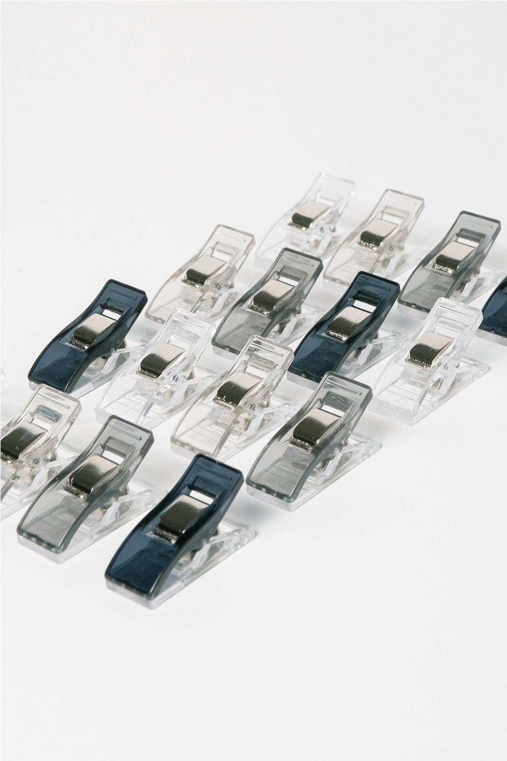 Set of clear plastic clips with blue accents on a white background