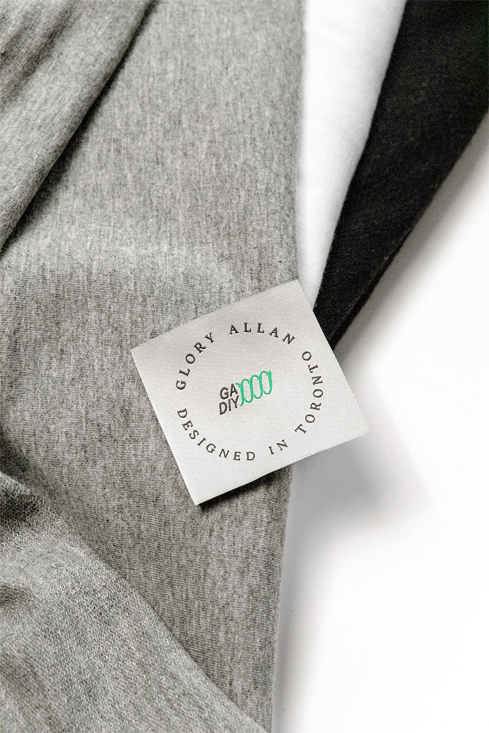 Layered fabrics in black, heather grey, and snow white for the Regular T-Shirt DIY Kit and Pattern