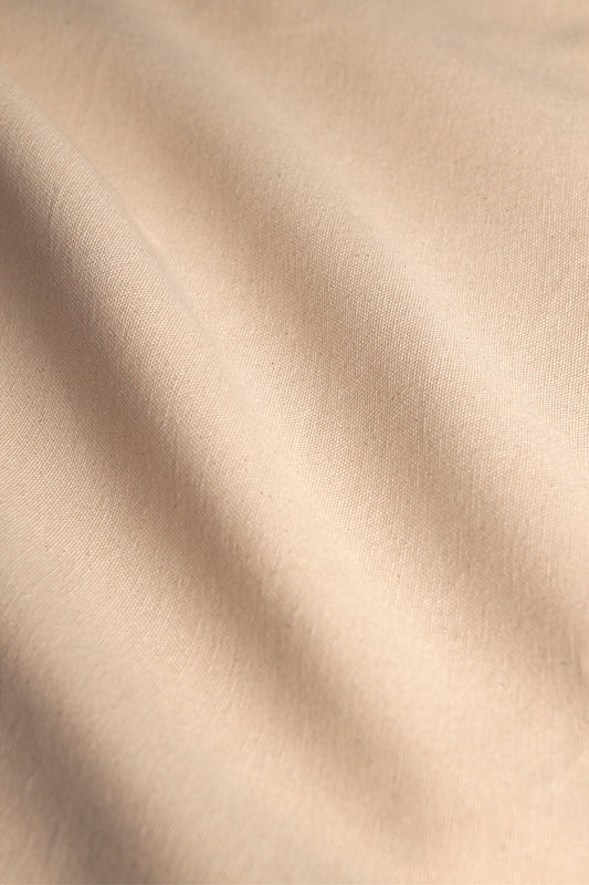 Natural cotton canvas fabric with a durable weave, ideal for crafting projects and sewing