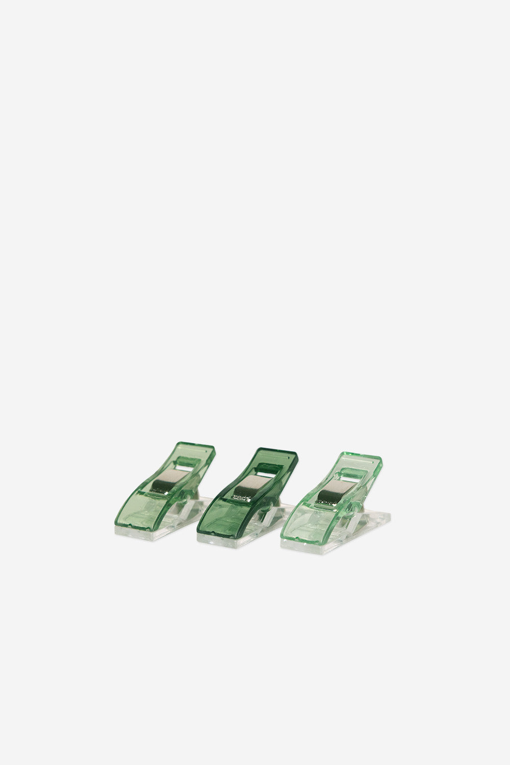 Three green clips on a white background