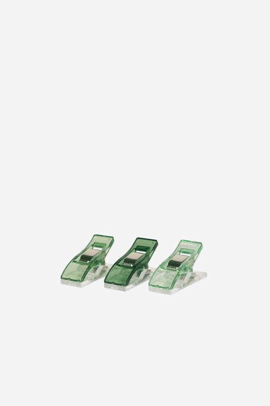 Three green clips on a white background