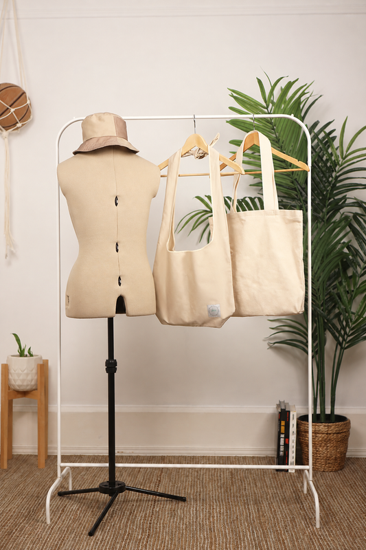 Bucket Hat, Welter Tote Bag, and Tsuno Bag on a clothing rack and mannequin display.