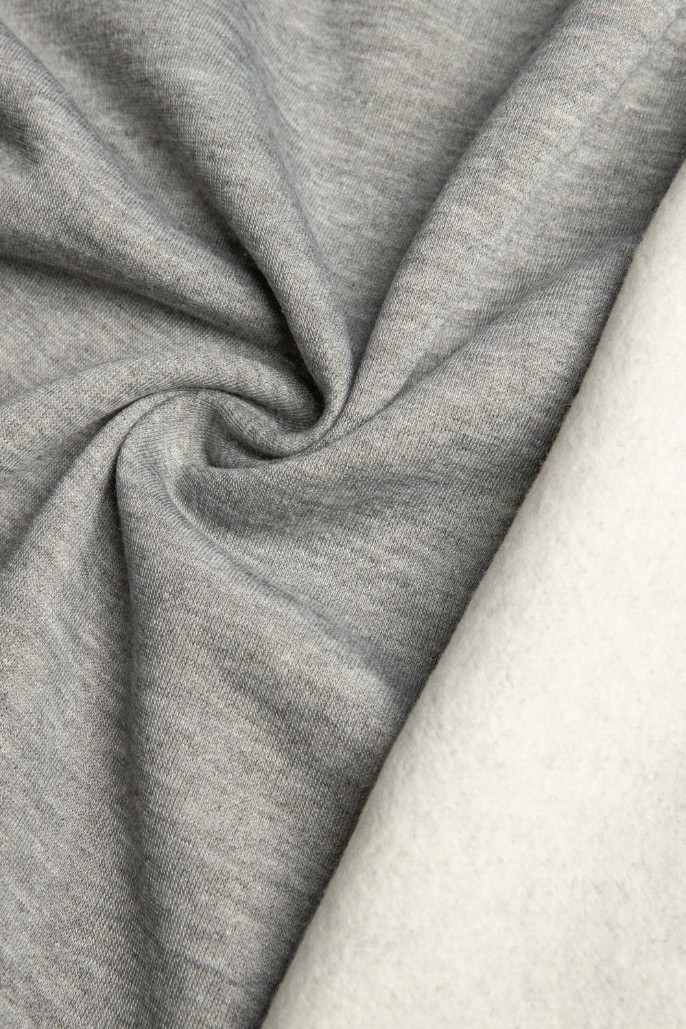 Heather-gray sweatshirt fleece showing the smooth face and soft brushed backing